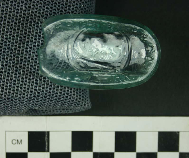 Figure 6.8. Fragment of a food-related bottle, from Area C of the Pine Level site. The final identifiable bottle in Area C is an oval-shaped base embossed with H.K. & F.B. Thurber & Co.