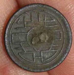 Figure 6.11. Metal disc located in Area B, Unit 3, 10-20 cmbs, left, and the Chinese symbol for double happiness, or shuangxi, right. Note that the metal disc is 1.4 centimeters in diameter.