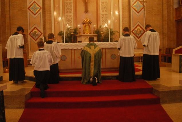 As the priest turns toward the people, the servers turn in toward the minister and accompany him to the altar of sacrifice where he will kiss it.