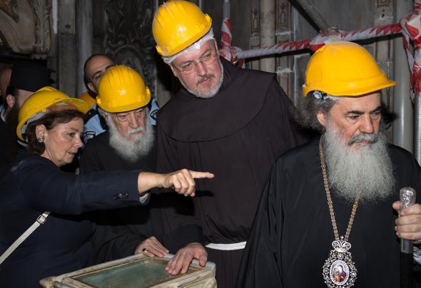 Chief Scientific Supervisor Antonia Moropoulou shows the exposed tomb to (from left) representatives of the Armenian Patriarch