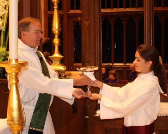 The Deacon will take the chalice and bow slightly. Bow in response. Hand the small cruet of water to the Deacon with the handle toward the Deacon.
