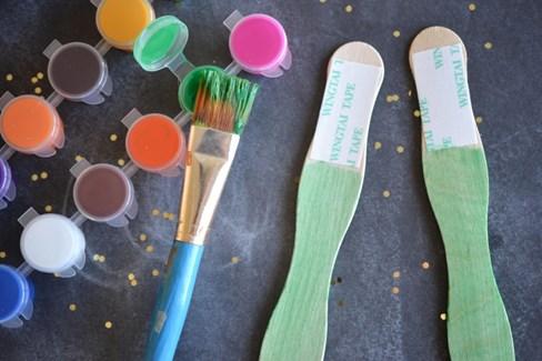 To begin these handprint flower DIY bookmarks for kids, have children paint their Sticky
