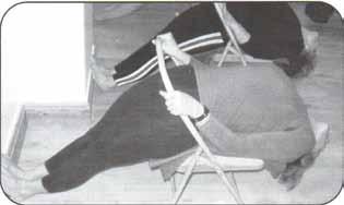 Bent knees to a wall. Arms over head. Top knee-caps touching the wall. Use knee-caps as a brake.