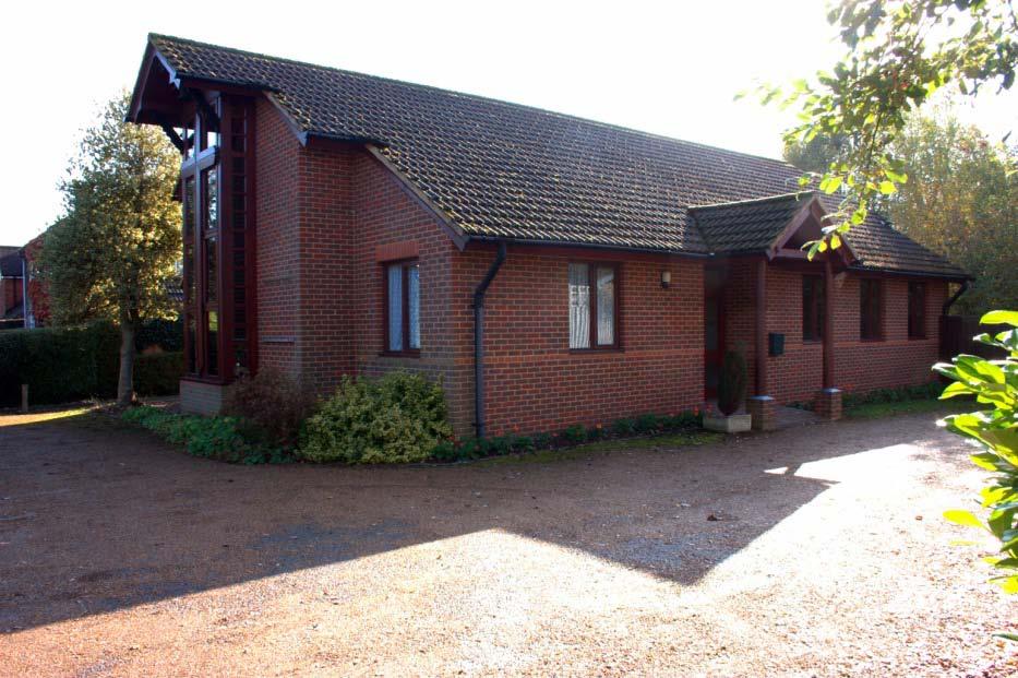 There is a tarmac area in the garden, together with a rough grassed area, which is currently used for parking by the Sunday congregation and guests at large weddings and funerals.