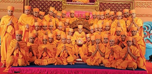 (L) Giving the guru mantra. (A) Pujya Mahant Swami Maharaj with the newly initiated sadhus The diksha rituals took place on the main stage of Narayan Mandapam.