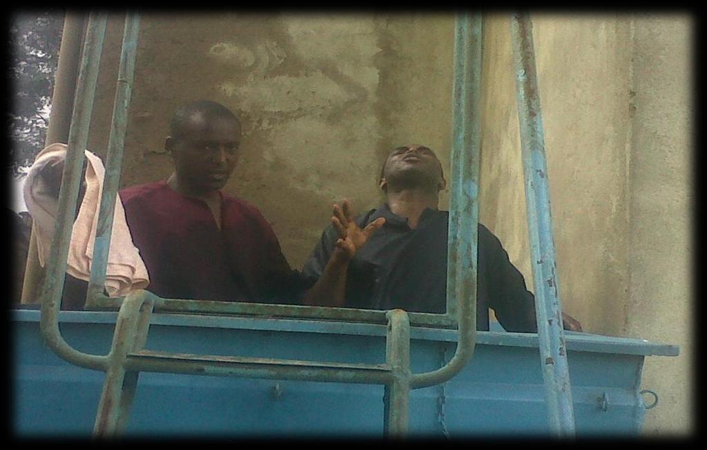 Photo 3: Bro Duncan (red) after baptizing Bro Stephen (blue). In this photo, Bro Stephen is under an anointing of the Holy ghost.