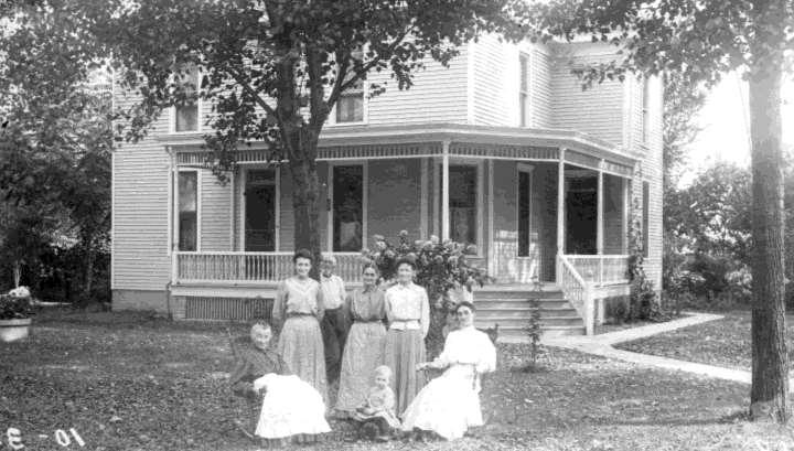 his front yard. Wife Frances is seated on left.