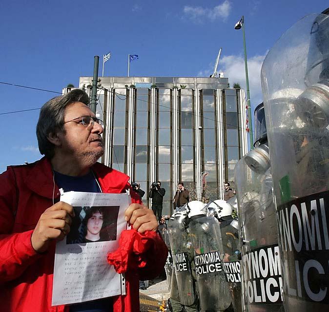 Page 10 of 16 A man showed a picture of Alexandros Grigoropoulos, 15, at the parliament building in Athens Tuesday.