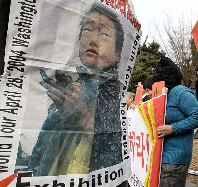 Page 14 of 16 Former North Korean defectors rallied Tuesday in Seoul, showing a poster of a North Korean child reportedly
