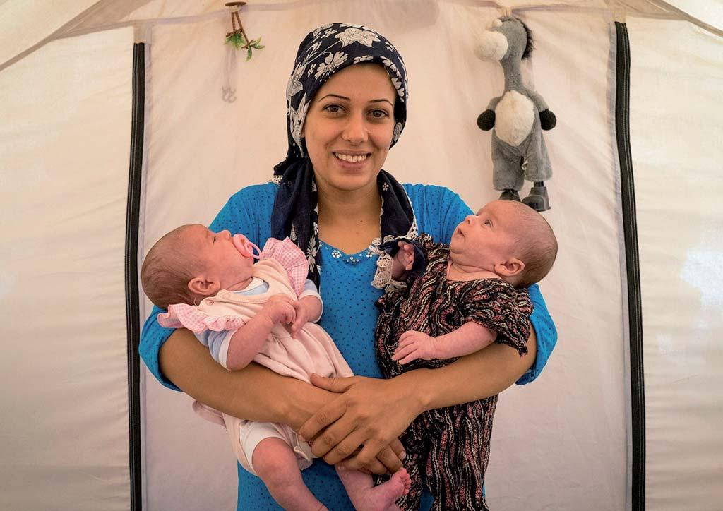 A syrian refugee woman with her two twin babies. She left Syria while she was pregnant.