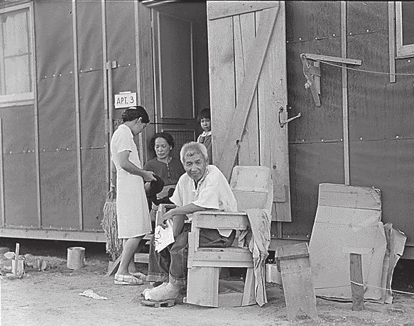 Note the chair which was made of scrap lumber, and the wooden shoes known as Getas made by evacuees.