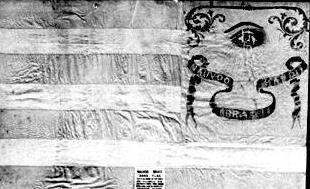 The Brass Band marched under this hand-sewn blue and white stripped silk flag, adorned with a red all-seeing eye which now hangs in Salt Lake City s Daughters of Utah Pioneers museum.