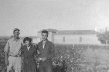 Photo courtesy Delores Romero Santiago Romero (left), wife Magarita, and son Jim stand in front of La Sagrada Familia de Lemitar church about 1960 before the bell towers were added.