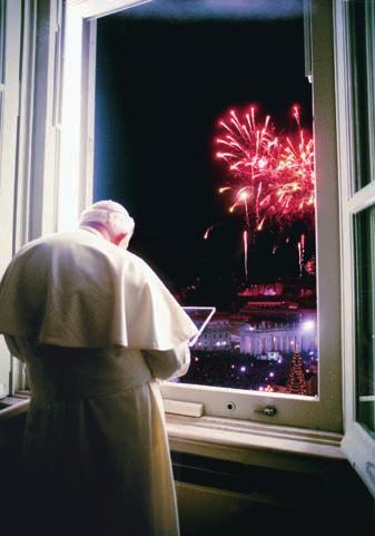 A new Millennium. The pope looks out from his window as a crowd in St.