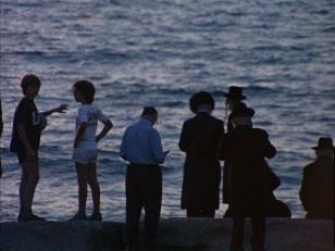 RG-60.5069 Location filming of life at the seashore in Tel Aviv, Israel. Men fish at the water s edge, and families gather to enjoy the ocean views. A group of Hasidic men read from the Torah.