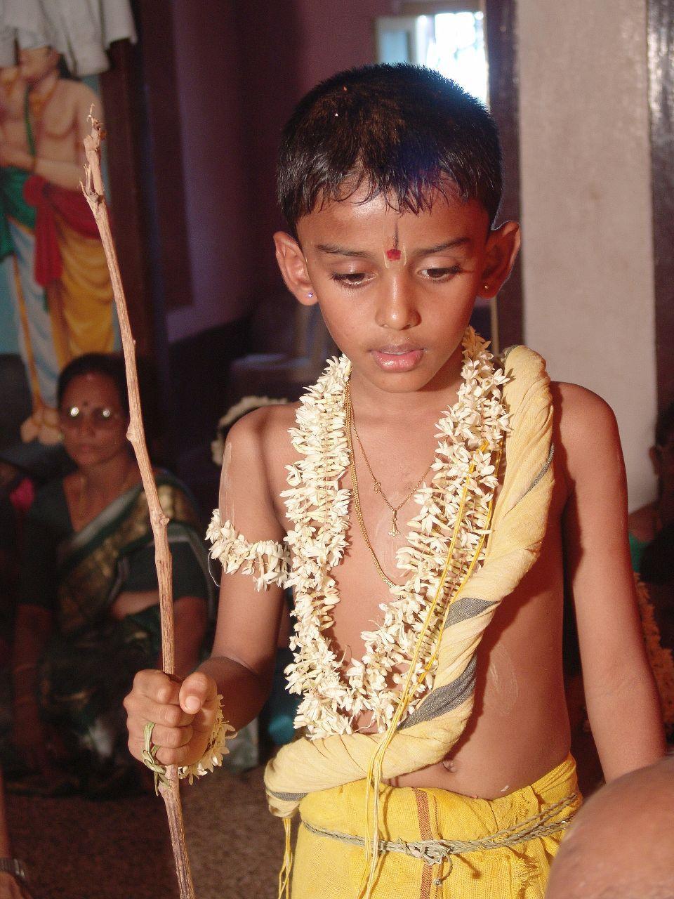 A Tulu Madhwa Brahmin boy during his upanayana ritual. The thin, yellowed,yajnopavita thread runs from left shoulder to waist.