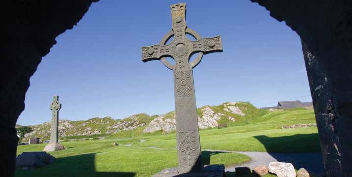 Looking through doorway of St Columba s Shrine to the replica of St John s Celtic Cross, Iona Abbey, Mull, Scotland. JUNE St Justin M Jesus prays for all believers.