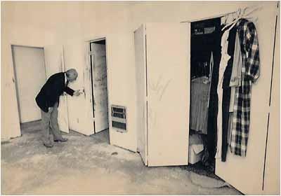 San Bernardino County Sheriff Floyd Tidwell examines blood stains found on the doorway leading into the master