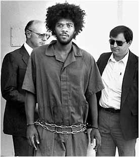 Prison escapee Kevin Cooper, center, escorted by law enforcemnet officers, is seen in this 1983 file photo shortly after his arrest in Santa Barbara,