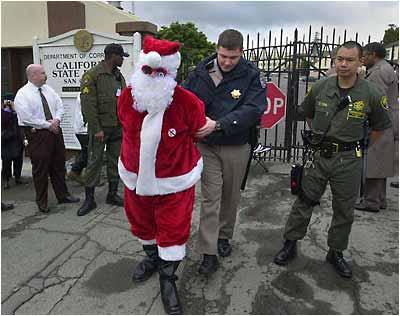 (AP Photo/Marcio Jose Sanchez) Hugh Romney, who goes by the name "Wavy Gravy," is led away from the gates of San Quentin State Prison during a protest, Tuesday, Feb. 3, 2004, in San Rafael, Calif.