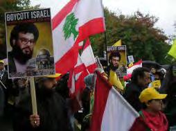 17 Demonstrators in London (October 22, 2096) carry Lebanese and Hezbollah flags and pictures of Hezbollah leader Hassan Nasrallah.