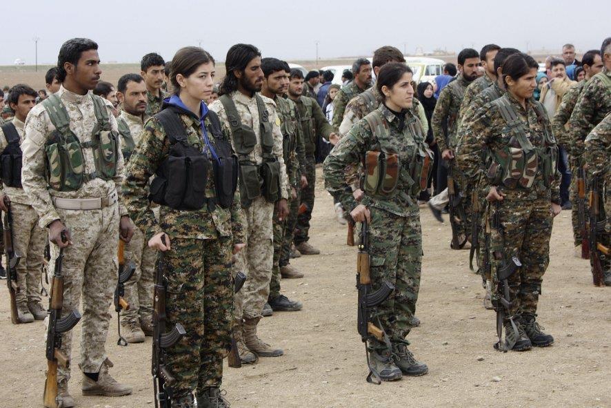 Sanadid, YPG, and YPJ fighters at the funeral in Ja'ada of three Sanadid members killed fighting the Islamic State.