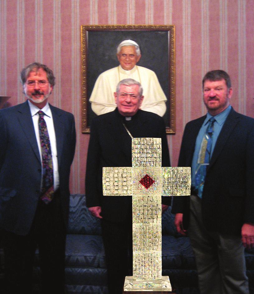 The cross will be presented to the Pope by Kuhn and Priest.
