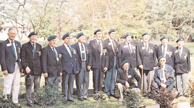 UNITED IN THOUGHT All the Veterans from 3 Commando Brigade in front of the memorial stone to