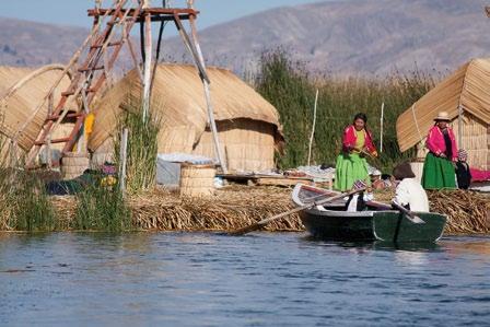 Nelson Coila (left) adds a fresh layer of totora reeds to Utama, the floating island he and his family (above) inhabit on Lake Titicaca.