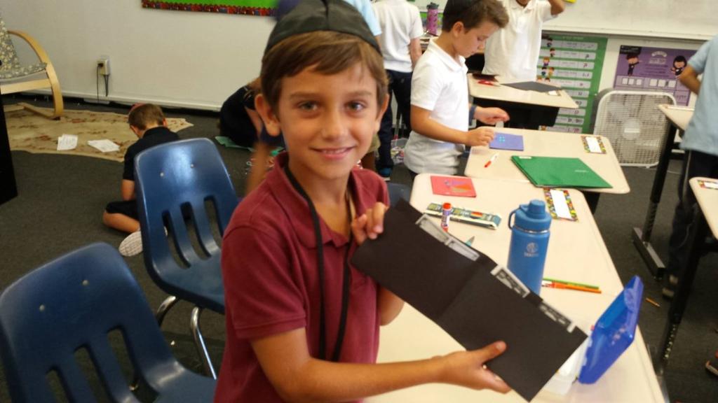 3rd graders making wallets for the Mitzvah and Mastery Dollars they earn in class.