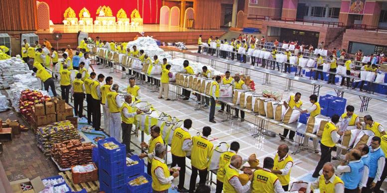 BAPS volunteers preparing food kits at Swaminarayan Mandir, Ahmedabad BAPS provided and distributed medicines and first aid materials to needy patients, families, medical personnel in affected