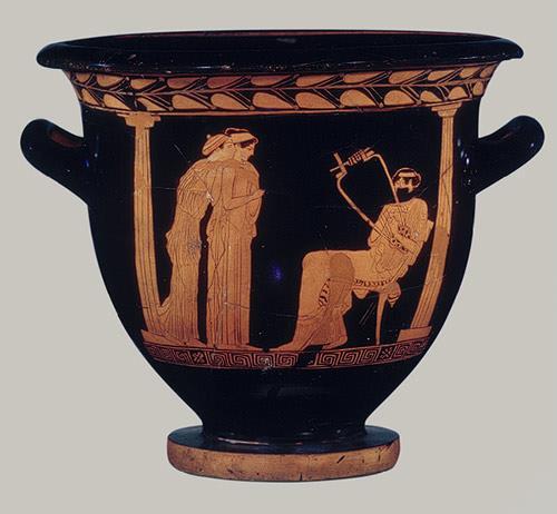One maenad plays the aulos, her cheeks puffed up, a second one plays the lyre, while a third carries a thyrsos and holds a kylix by its foot as she opens her mouth to sing.