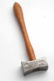 Cast engraved steel, wooden handle. Engraved on one side of the hammer head is the verse: Are not all my words as fire speaks G-d and as a hammer that shatters rock. Mirror writing with vowels.