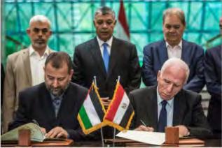 12 Azzam al-ahmed (right), head of the Fatah delegation, and Saleh al-'arouri (left), head of the Hamas delegation, sign the reconciliation agreement in Cairo.