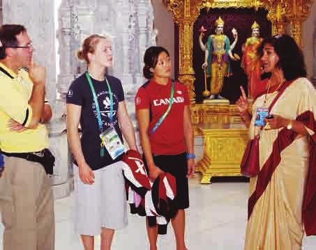 A volunteer explains to athletes about the deities in Akshardham Mandir communication skills in English or Hindi. If the applicant was a student then he or she was told not to miss studies.