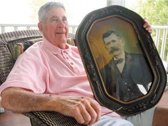 REAL SON OF CONFEDERATE VETERAN MARY KILLMON/STAFF PHOTO Dinwiddie County native Lucas L. Meredith Jr., 84, poses with a portrait of his father, who fought for the South.