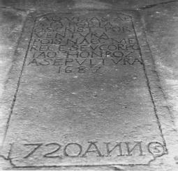 customary spacing between the words.an English translation of the inscription is shown below it. The inscription on the upper half of a paving-stone memorial in the Guia Chapel.