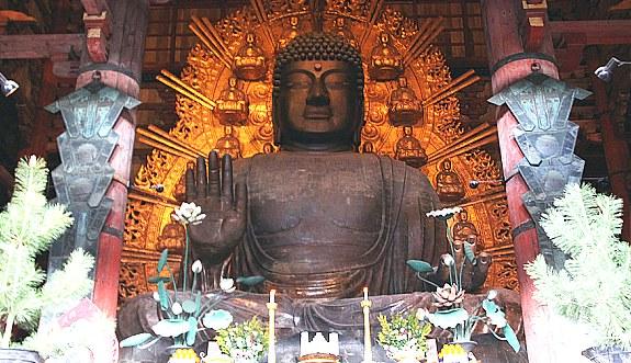 A seated Aminda (the celestial Buddha, Vairochana) is found