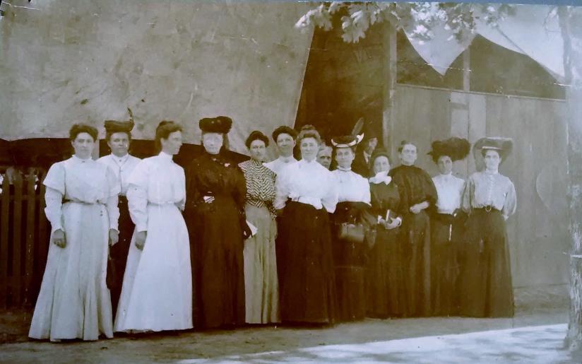 Sam Laura Jones, stands 3 rd from right wearing black with a group of community women at the