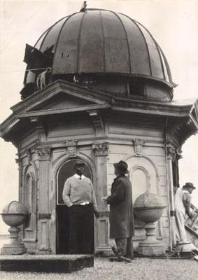 Left: Deacon of Third Baptist Church, C.A. Harris, speaks with news reporter on the roof of the former Charles Goodall Mansion where Third Baptist Church now stands, circa 1952.