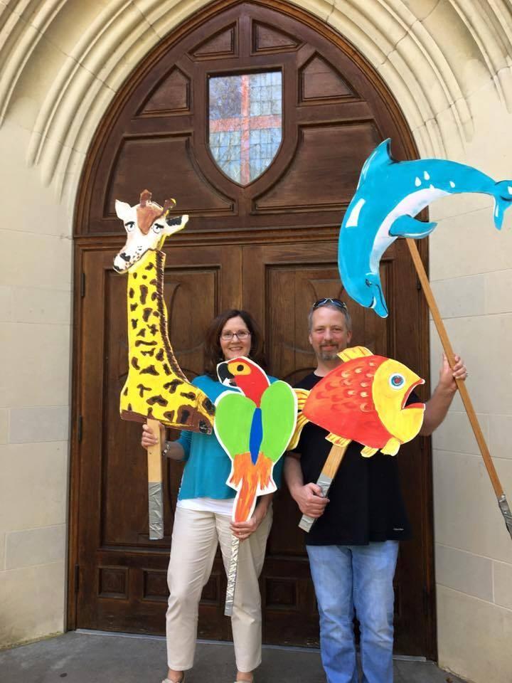 Director of Children s Ministry s Mary Nell Prichard and Chance Morgan pose with creation banners.