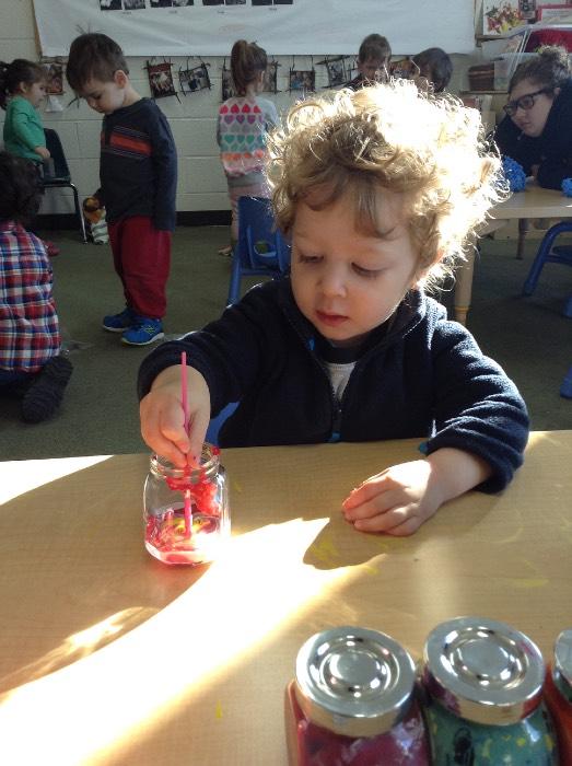 The children poured primary colors into jars.