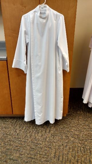 II. Glossary Alb The long sleeved white garment that is worn over your clothing. It has straps inside the waist that tie like shoe laces.