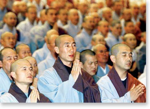 the religions originated. The Buddhist monks (below left) are praying in Seoul, South Korea.