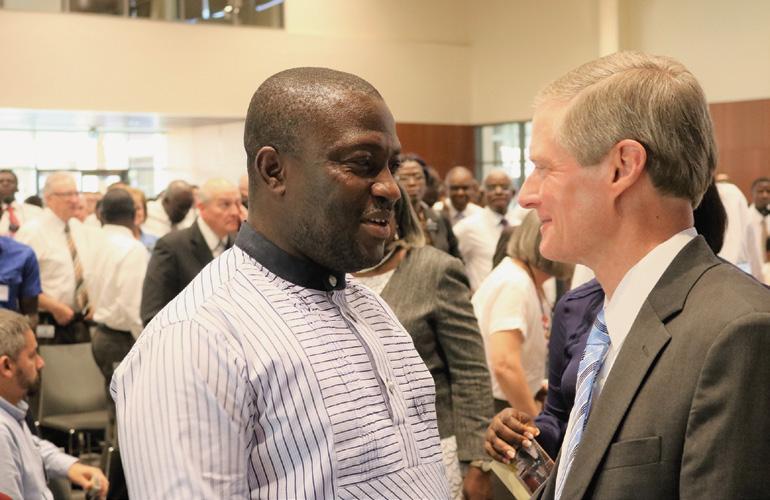 AFRICA WEST AREA LOCAL PAGES Reverend Father George Arthur, Chaplain General of the Ghana Police, greets Elder Bednar.