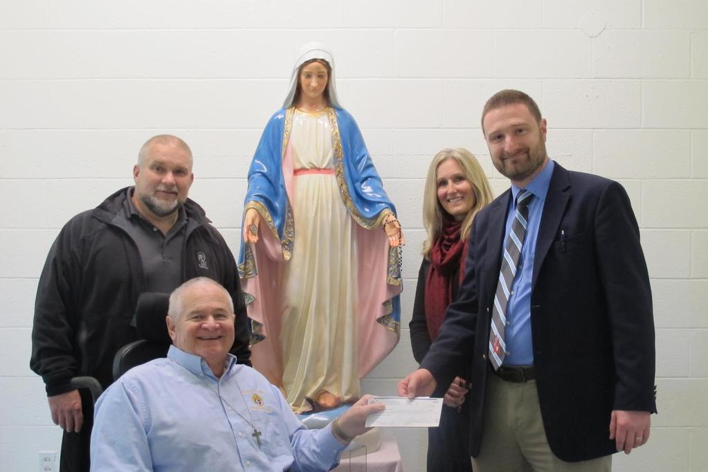 Bishop Flaget Council #13053 Financial Secretary presenting the council's donation of $2,250 toward the building of an accessible playground to Principal Justin Fout.