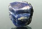 Most scholars agree that it was soe kind of blue stone, taking it s color fro the flower.