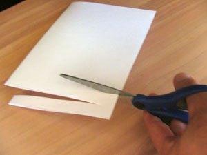 Make a first cut away from the fold across the paper stopping a few