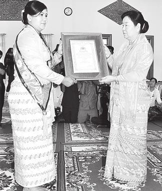 titles and certificates to Daw Khin Daw Khin Saw Hnin, wife of Vice-President Thiha Thura U Tin Aung