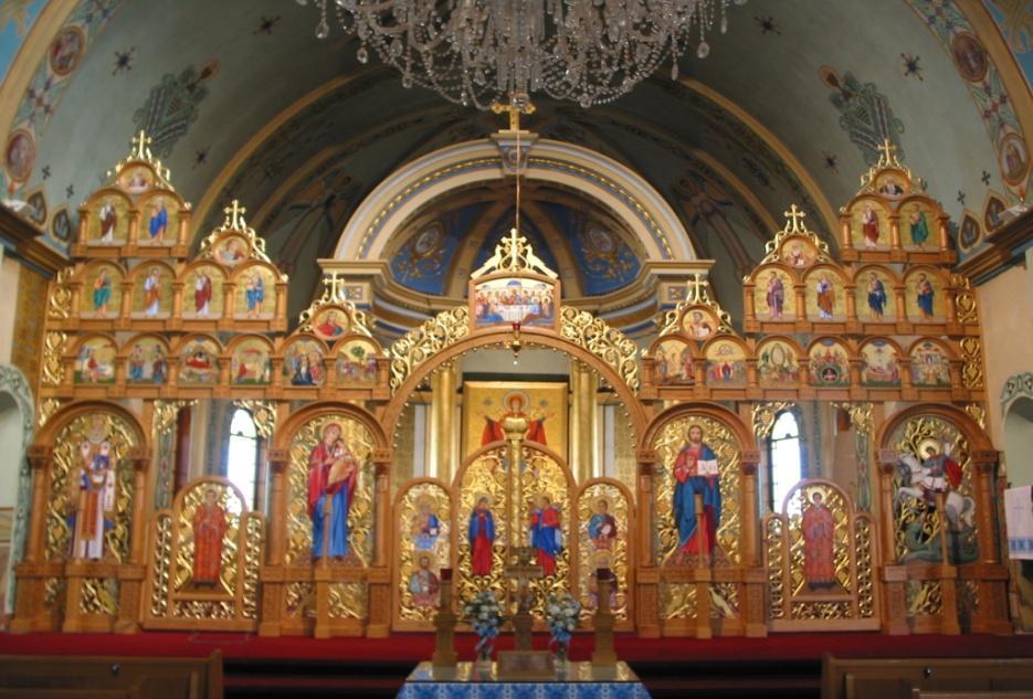 The iconostasis is the most distinctive feature of an Eastern Church. It is richly decorated with icons. The first level of the icon screen has six icons, three on either side of the royal door.